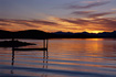 Gentle waves make their way past a small boat dock and towards the shoreline of Fritz Cove on a warm summer evening.