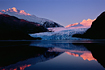 Taken in December, the Mendenhall Glacier reflects in the waters of Mendenhall Lake and glows in the magic light right before sunset.